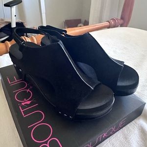 Brand new Boutique black wedge heels never worn